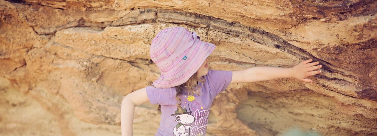 child viewing dinosaur bone at Mill Canyon Dinosaur Bone Site